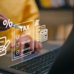 A person uses a laptop with a stylus, surrounded by holographic tax-related icons like a checklist, percentage symbol, and calculator, highlighting efficient financial management and tax filing. Stay ahead of tax changes in 2025 with cutting-edge tools and insights.